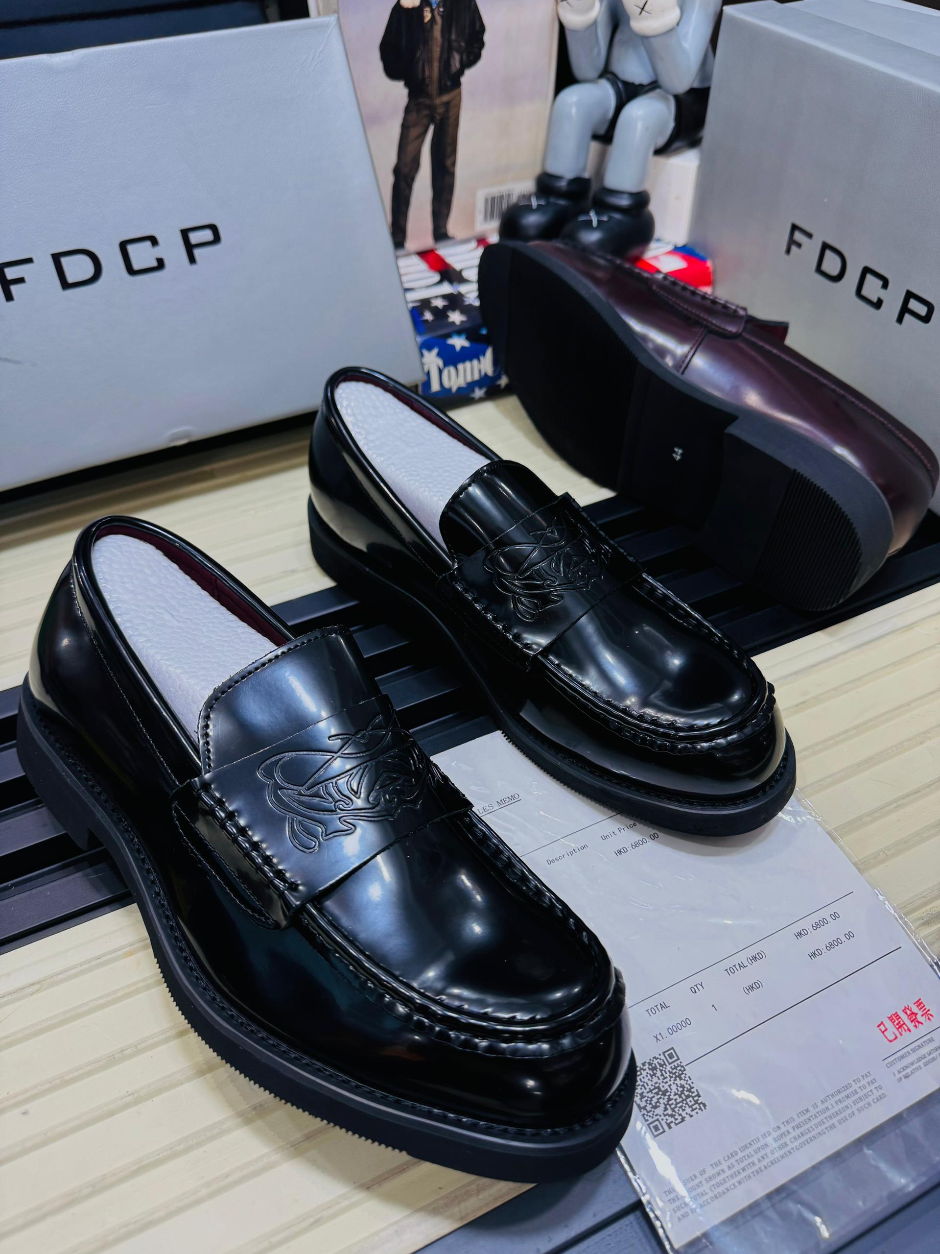 Premium FDCP leather loafers FDCP men's burgundy high-gloss leather loafers with embossed strap detail and thick black rubber sole, displayed with branded grey shoebox and sales receipt.