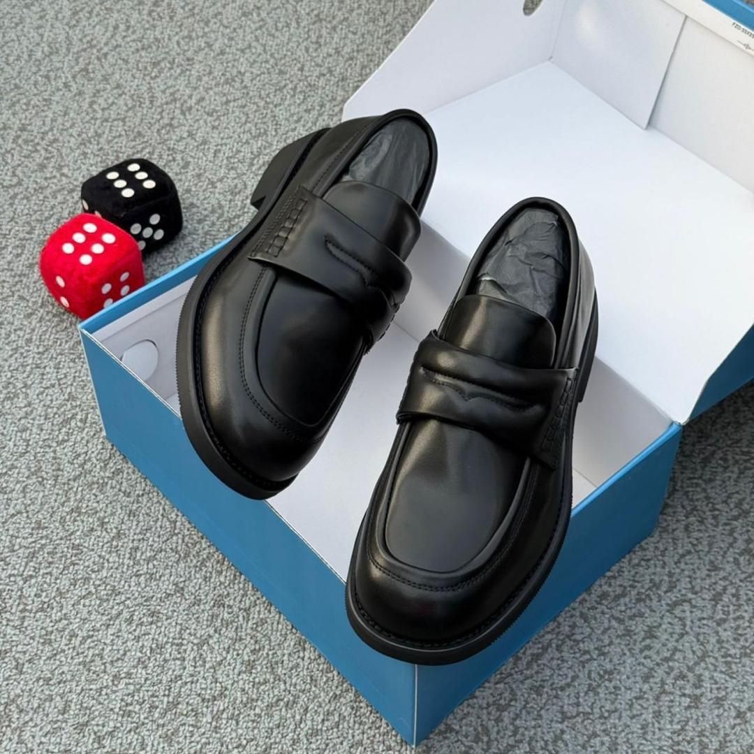 Authentic leather penny loafers Men's chocolate brown leather penny loafers with black rubber sole, displayed in open blue shoebox with decorative dice on grey carpet.