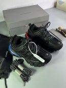 Men's luxury black Balenciaga Track sneakers with blue and red neon sole accents, extra laces, and grey branded box.