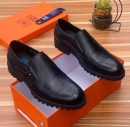 Franco Binetti men's black pebbled leather brogue loafers with ridged rubber sole, displayed in orange branded shoebox on wooden surface.