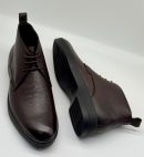 Bally men's dark brown pebbled leather chukka boots with tonal laces and black rubber sole, displayed on white background showing side profile and sole detail.