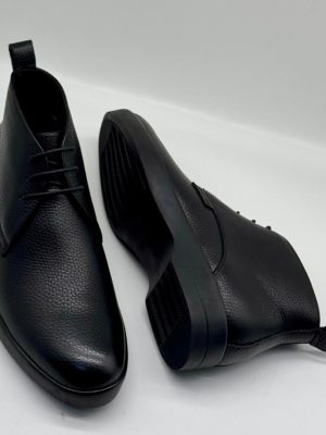 Bally men's dark brown pebbled leather chukka boots with tonal laces and black rubber sole, displayed on white background showing side profile and sole detail.