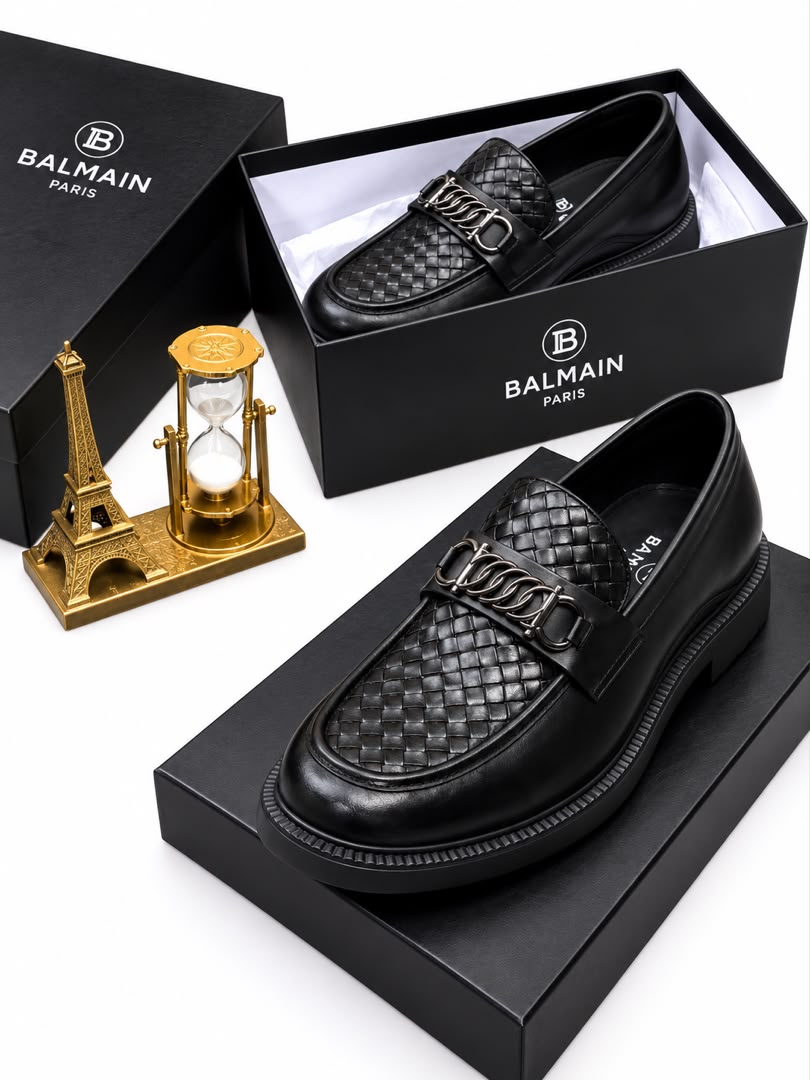 Brown men's woven leather Balmain loafers with silver chain-link hardware and black rubber sole.