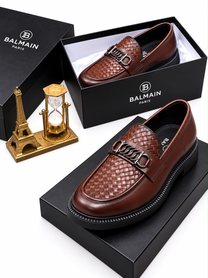 Brown men's woven leather Balmain loafers with silver chain-link hardware and black rubber sole.
