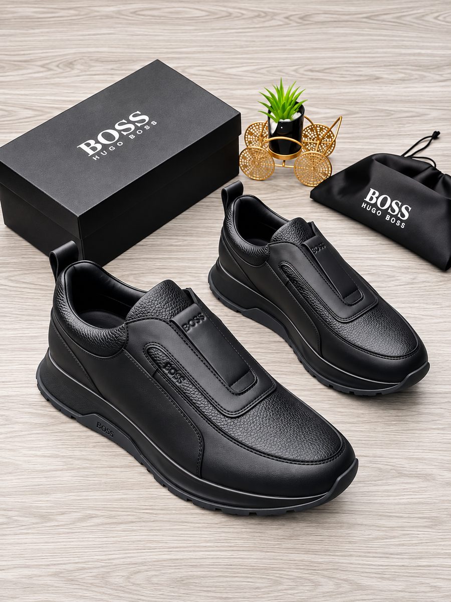 Hugo Boss navy leather slip-on sneakers Navy men's leather Hugo Boss slip-on sneakers with white rubber sole and elastic strap.