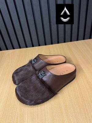AMIRI luxury fur slide mules in white, black, and brown with authentic leather upper, plush fur detailing, signature AM logo, and cushioned sole displayed with original black AMIRI box