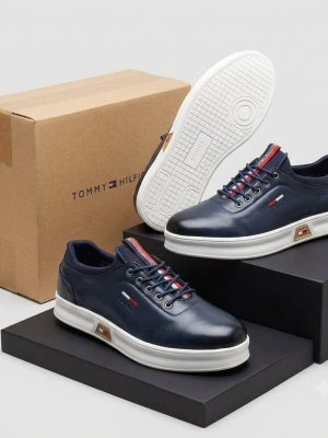 Navy men's leather Tommy Hilfiger sneakers with red and white striped detailing and white rubber sole.