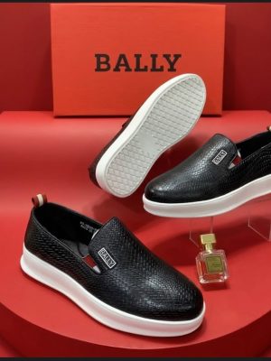Dark brown men's woven leather Bally slip-on shoes with white rubber sole and metallic logo plaque.