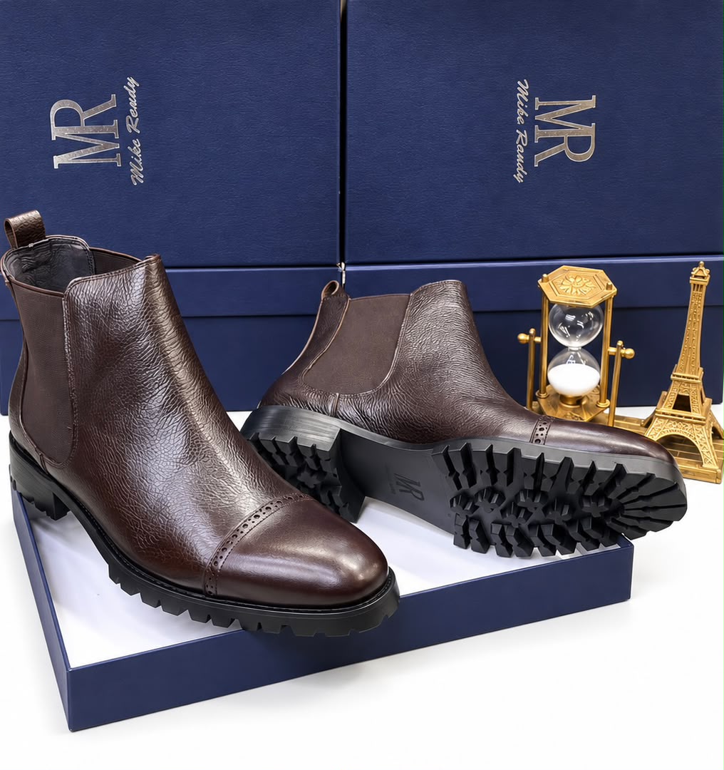 Dark brown men's textured leather Mike Randy Chelsea boots with brogue cap-toe and rugged rubber lug sole.